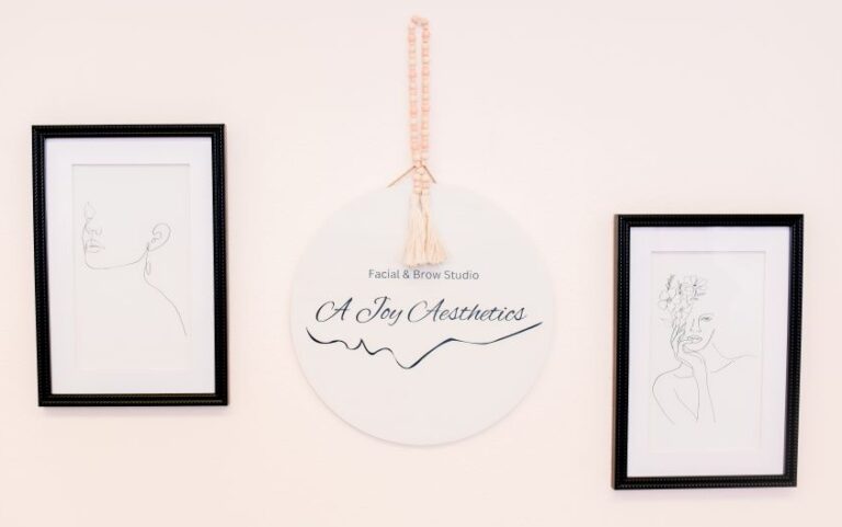 A Joy Aesthetics wall decor with logo